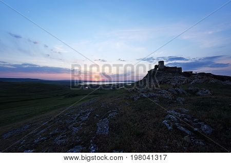 Enisala fortress in Romania with a beautiful summer sunset