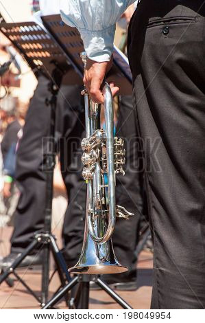 Musician holds the trumpet. Artistic performance of the brass band. Musical instrument