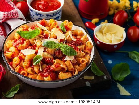 Pasta with spicy tomato sauce, parmesan and basil. Pasta Chifferi Rigati.