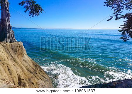 Surfers wait for the next big wave in the waters off of Capitola California