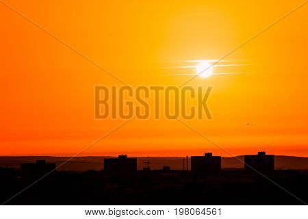 Photo of beautiful orange sunset on the city of Badajoz silhouette city in sunrise on seashore peaceful landscape sun down on town on warm weather heat concept