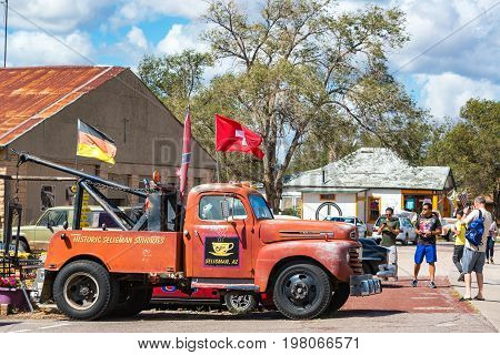 SELIGMAN AZ - SEPTEMBER 16: Tourists take pictures of an old tow truck on Route 66 in Seligman AZ on September 16 2015