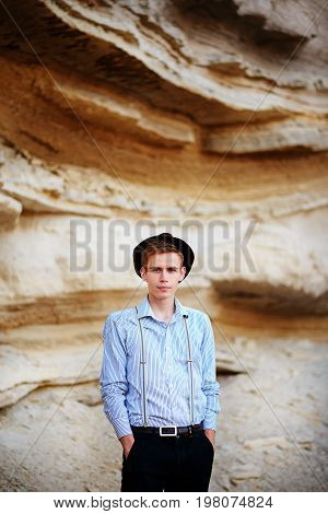 Stylish Attractive Man Stands In The Middle Of A Sand Quarry And Poses On The Camera