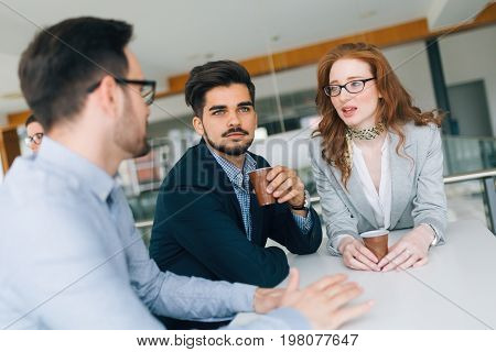 Business partners and colleagues having conversation during coffee break