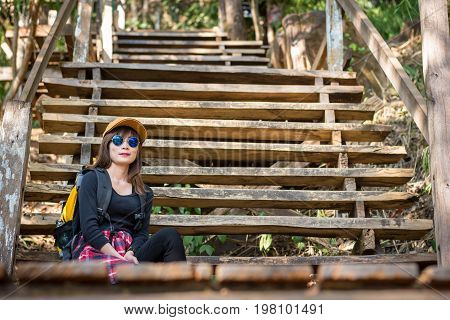 Tourist Young Woman Wearing Hat Enjoying Sitting On The Stairs Mountain.
