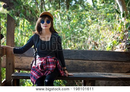 Tourist Young Woman Wearing Hat Enjoying Sitting On The Stairs Mountain.