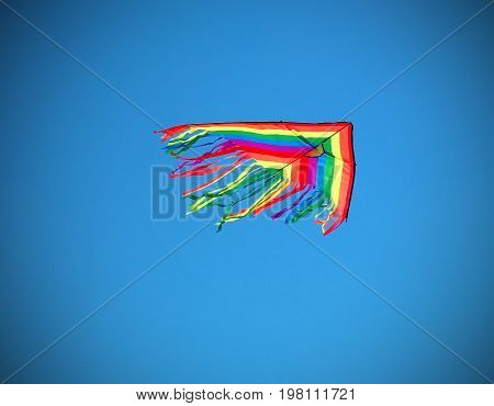 Big Kite Flying High In Blue Sky In Summer