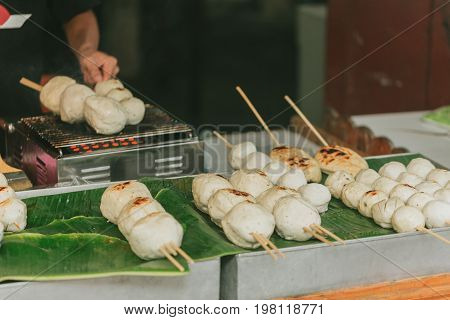 Big Meat Ball From Pork Product With Bamboo Stick Grill Sale At Street Food In Thailand.