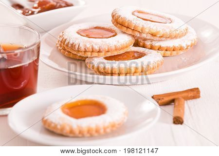 Teatime biscuits with cinnamon tea and jam.