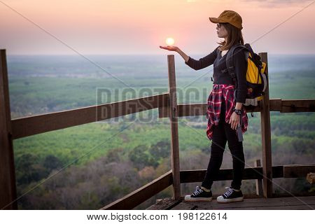 Tourist Young Woman Stand On The Moutain Watching The Beautiful Sunset.