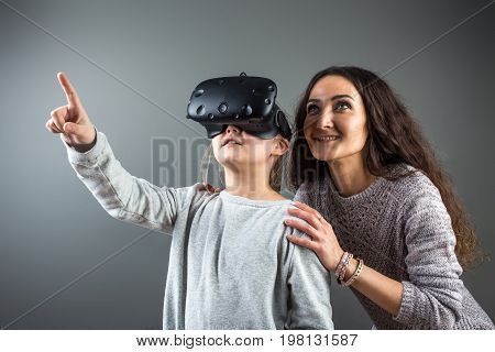 Young Woman Playing Outdoors With Cute Little Girl. Watching Through Vr Device.