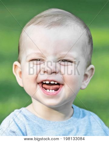 laughing little boy in park at summer day