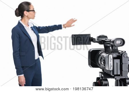Beautiful Female Newscaster Presenting Something In Front Of Camera, Isolated On White
