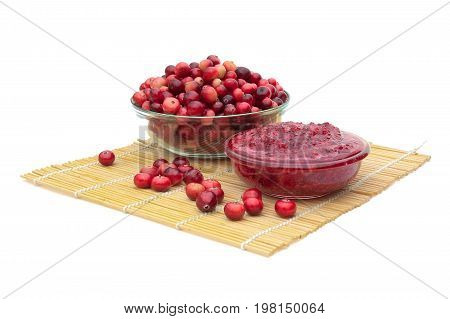 Cranberries and cranberry jam on a white background. Horizontal photo.
