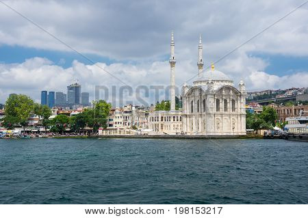 ISTANBUL TURKEY - JUNE 25 2015: Ortaköy Mosque (Grand Imperial Mosque of Sultan Abdulmecid) in Istanbul Turkey is situated at the waterside of the Ortakoy pier square one of the most popular locations on the Bosphorus