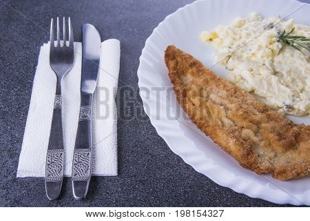 Fried pork with potato mayonnaise salad on the white plate