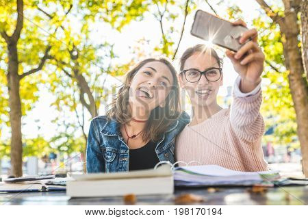 Girls Studying And Taking A Funny Selfie At Park