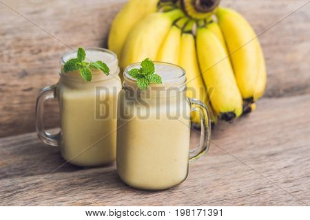 Banana Smoothies And Bananas On An Old Wooden Background
