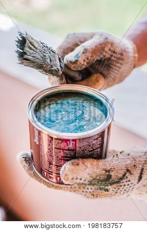 Open bucket of blue green paint isolated