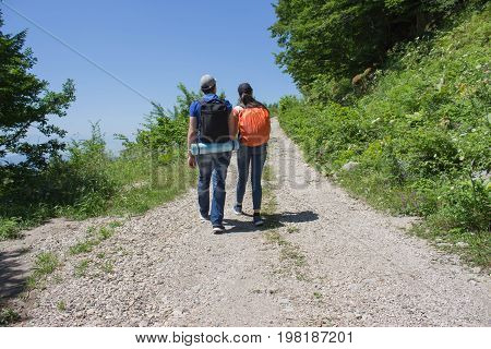 Active and healthy lifestyle on summer vacation and weekend tour. Active hikers. Travel adventure and hiking activity. Two young Tourists With Backpacks travel