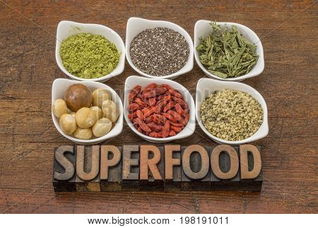 superfood abstract (matcha green tea, chia seeds, stevia herb, macadamia nuts, goji berry and hemp seed hearts) with a text in vintage letterpress wood type