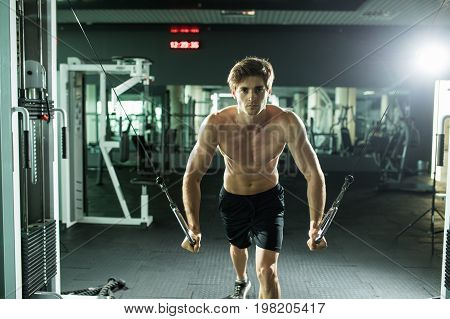 Muscular Man Lifting Weights In Fitness Gym Center