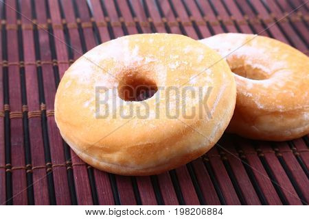 Homemade Doughnuts with Jelly filled and powdered sugar on Bamboo tablecloth. Selective focus