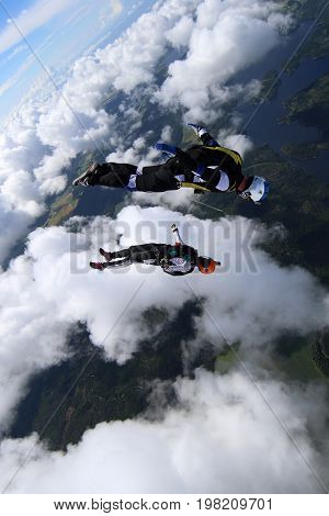 Skydiving over beautiful Norway. Clouds, sun and sky