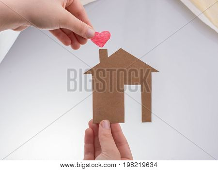 Hand Holding A Paper House On Canvas