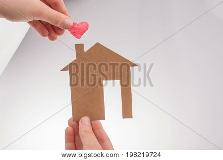 Hand Holding A Paper House On Canvas