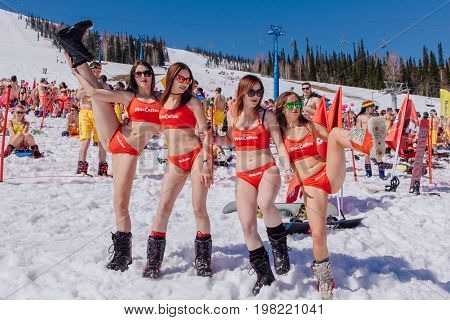 Group Of Young Happy Pretty Women On A Snowboard In Colorful Bikini.