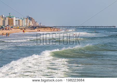 VIRGINIA BEACH, VIRGINIA - JULY 13, 2017:  Oceanfront hotels and fishing pier along the 3-mile long boardwalk and popular resort area on the Atlantic coast.