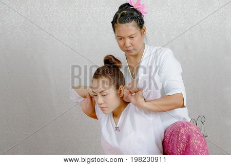 Asian Woman Getting Traditional Thai Stretching Massage By Therapist