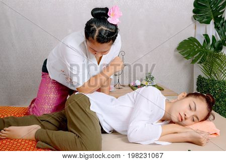 Traditional Thai Massage, Woman Getting Thai Deep Massage In Spa