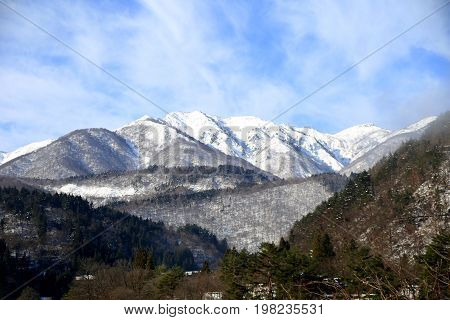 The white mountains of Shirakawa-go covered in snow in the winter.
