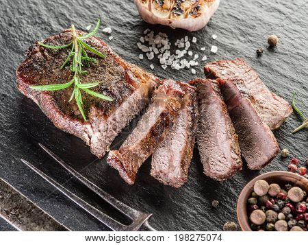 Steak Ribeye with spices on the graphite tray.