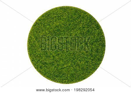 Artificial green grass in round plate on white background