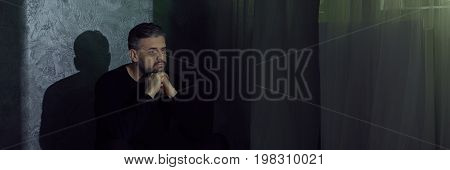 Sad Man Sitting Beside Wall