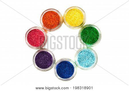 colored rice in glass jars is by colors of the rainbow. isolate