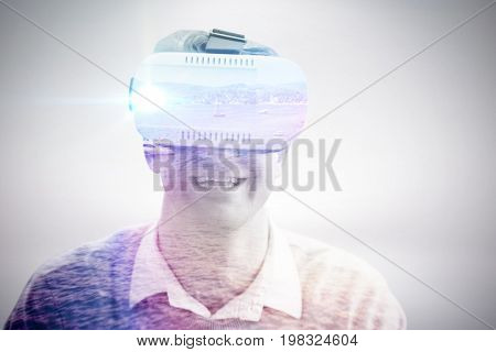 Smiling man wearing virtual reality glasses against boat on sea against sky