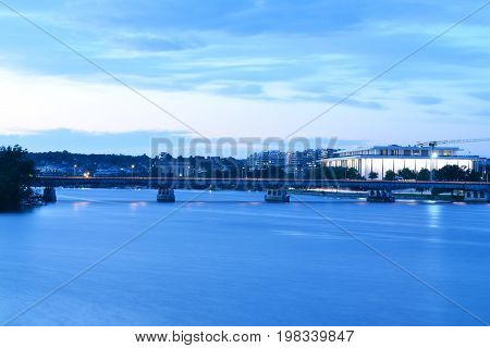 Panoramic photo of the Washington, D.C. waterfront along the Potomac River at dusk.