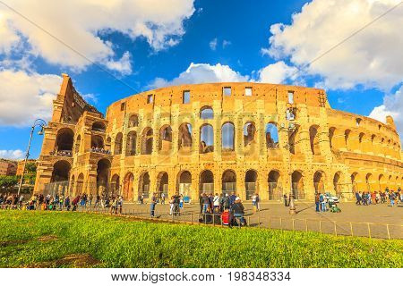 Rome, Italy - May 12, 2016: tourists in front of Colosseo at sunset, Colosseum, Flavian Amphitheatre, the largest amphitheater in the world and one of the symbols of Italy and Rome.