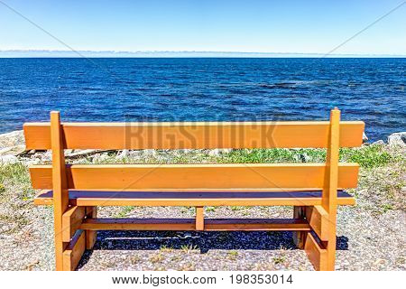 One Vibrant Vivid Empty Orange Bench In Front Of Ocean