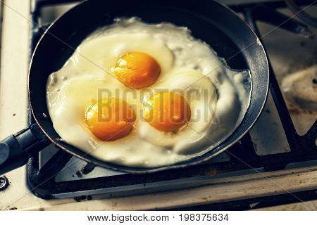 Eggs fry in a frying pan, morning
