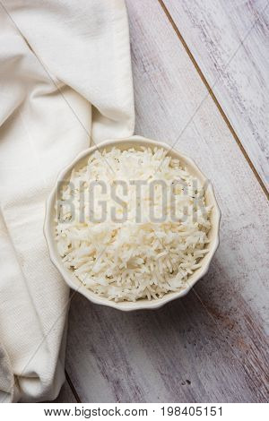 basmati rice in a ceramic bowl, indian white and long basmati rice cooked and served in bowl, selective focus
