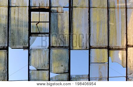 Old broken glass roof in abandoned factory