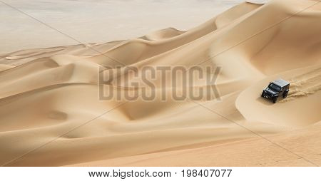 Car Driving In Rub Al Khali Desert At The Empty Quarter, In Abu Dhabi, Uae