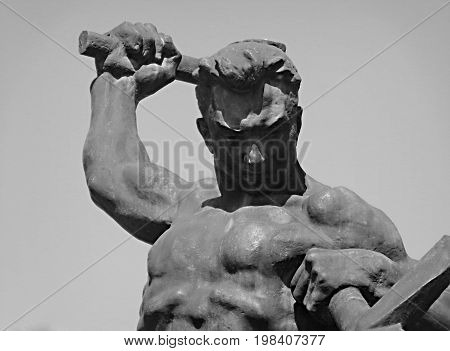 Kazakhstan, Ust-Kamenogorsk - August 02, 2017. Swords to ploughshares. The statue was designed by Yevgeny Vuchetich. Statue. Man. Muscular man. Sculpture.