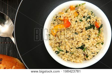 Hot cracked freekeh vegetable salad with onion roll
