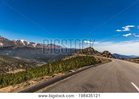 Trail Ridge Road is the name for a stretch of U.S. Highway 34 that traverses Rocky Mountain National Park from Estes Park Colorado in the east to Grand Lake Colorado in the west offering stunning mountain views.